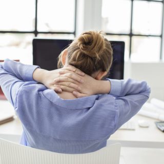 Tired businesswoman holding her nape